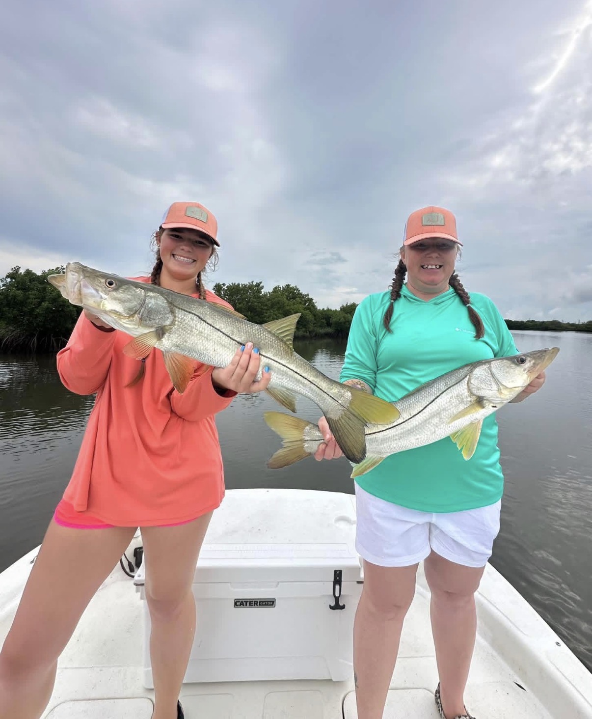 Two anglers smiling on the bow with a pair of big Nature Coast snook caught on a Big 3 Charters fishing trip.